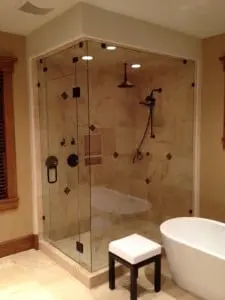 A modern bathroom with a glass shower door and a bathtub.